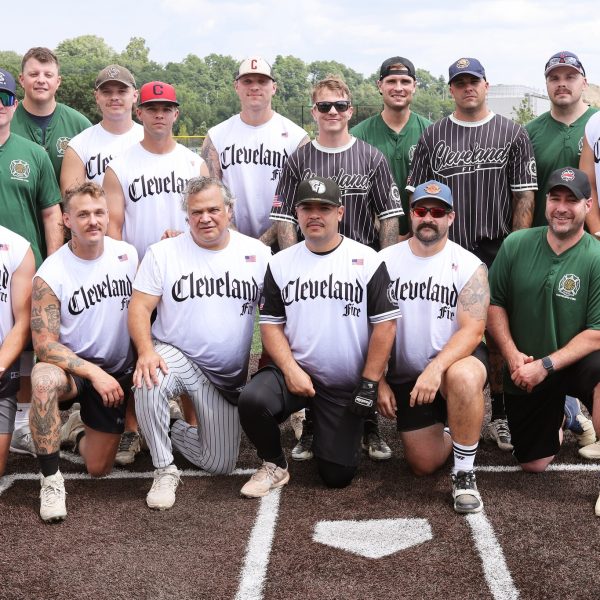 Cleveland Fire softball team posing together on the field before the Police/Fire game.