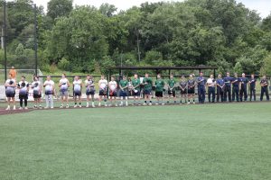 Cleveland Fire softball team members stand with hands over hearts during the national anthem before the Police/Fire game.
