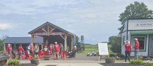 Audience seated outside the concert hall watching Santa and holiday performers on stage.