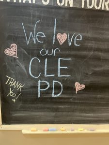 Chalkboard sign reading “We love our CLE PD” with hand-drawn hearts and “Thank you” written in chalk.