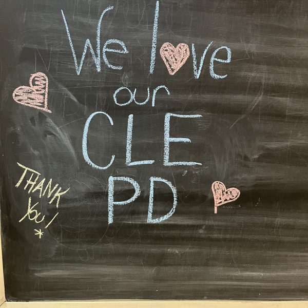 Chalkboard sign reading “We love our CLE PD” with hand-drawn hearts and “Thank you” written in chalk.