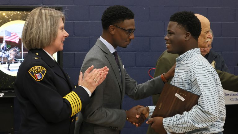 Chief Dorothy Todd and Mayor Justin Bibb congratulate Andre Willis of The Trash Boys during the Fourth District Community Relations Awards Ceremony.