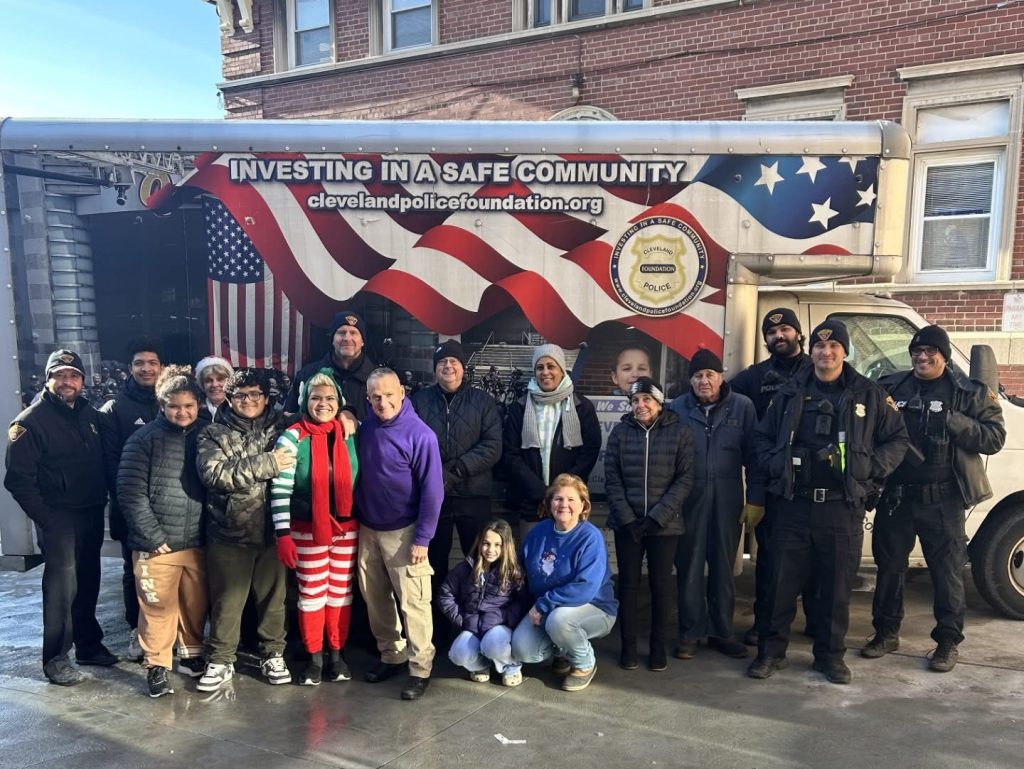 Cleveland police officers and volunteers preparing holiday gifts outside the Cleveland Police Foundation truck.