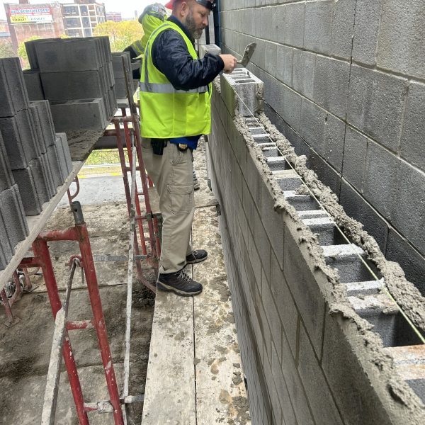 Lt. Lentz putting old skills to good use as he lays a block at the new headquarters.