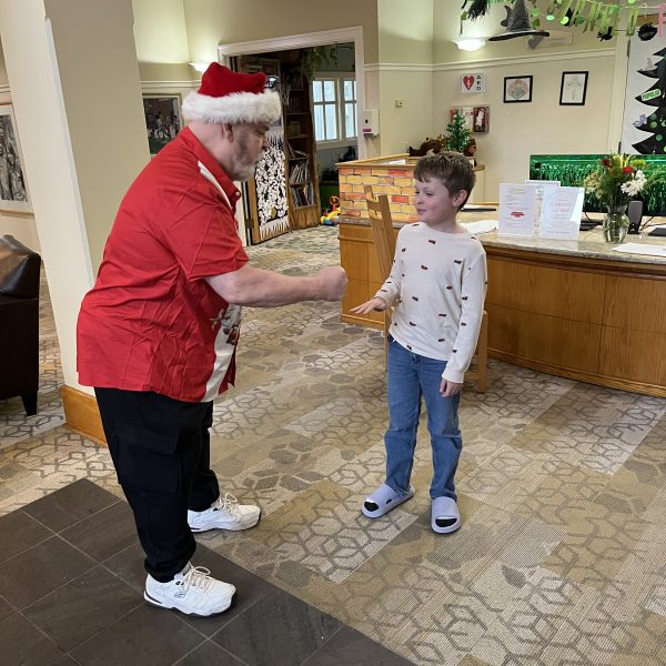 A volunteer dressed as Santa Claus speaks with a child during the Cops, Kids and Christmas event at the Ronald McDonald House.