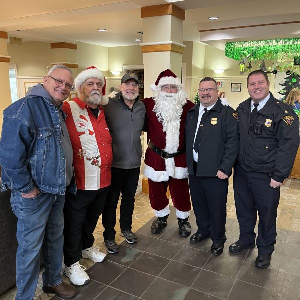 Santa Claus stands with Cleveland police officers and volunteers during the Cops, Kids and Christmas event at the Ronald McDonald House.