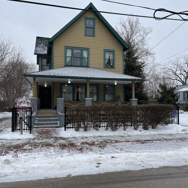Exterior view of the House From A Christmas Story in winter, showing the front porch and snow-covered sidewalk.
