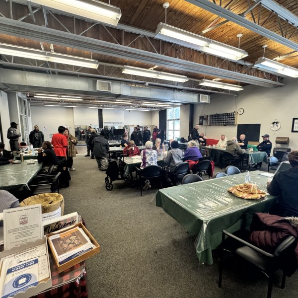 A wide view of the Gunning Recreation Center dining room filled with officers and community members during the Coffee with a Cop event