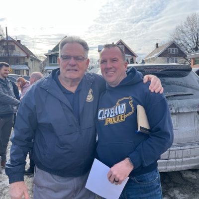 Bob Guttu and Officer Paul Beckwith pose together outside the Second District following the retirement ceremony